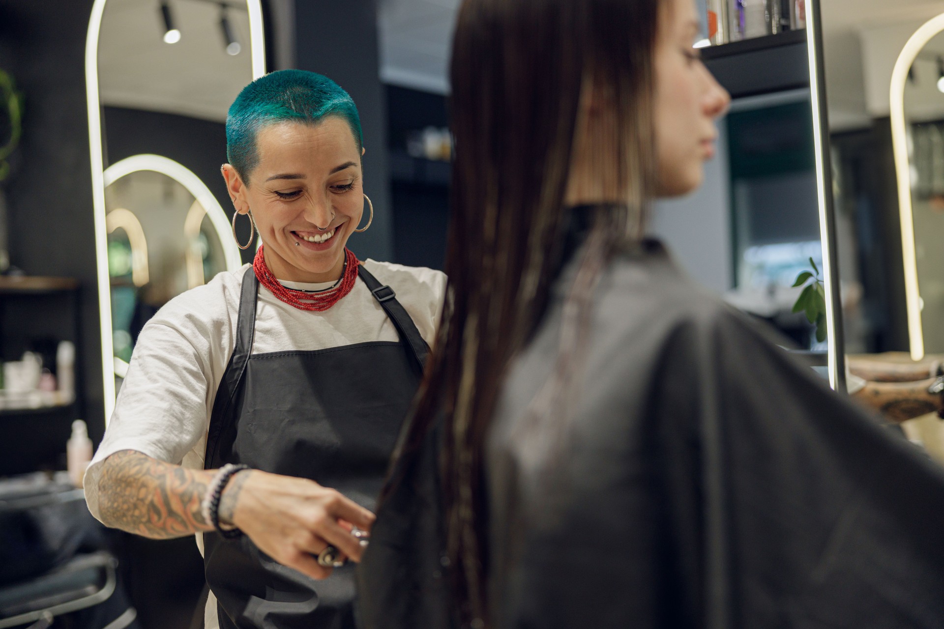 Hairdresser is cutting hair for female customers with scissors to cut hair in a beauty salon